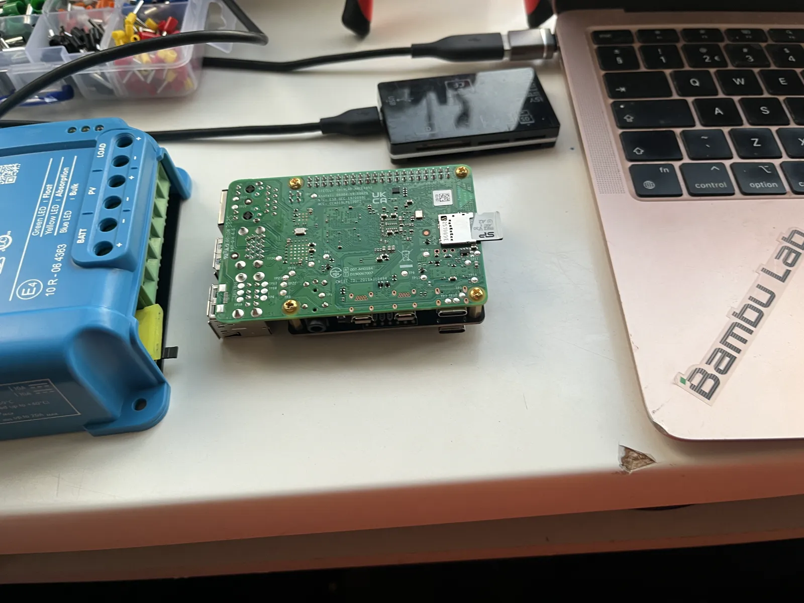 The Raspberry Pi turned over: the memory card sits in the slot on its underside, at the end opposite the USB sockets